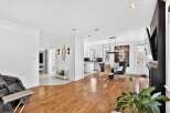 Step into luxury with this stunning property, featuring a bright and airy living space with beautiful hardwood floors.