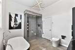 Step into luxury with this stunning bathroom featuring a modern design and high-end finishes.