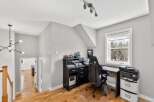 This stylish home office features a sleek black desk and chair, perfect for productivity.