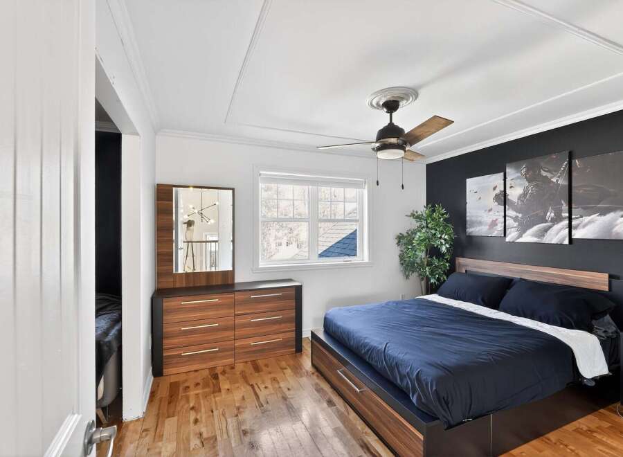 Step into this stylish bedroom featuring a modern design and inviting ambiance.
