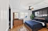 Step into this stylish bedroom featuring a modern design and inviting ambiance.