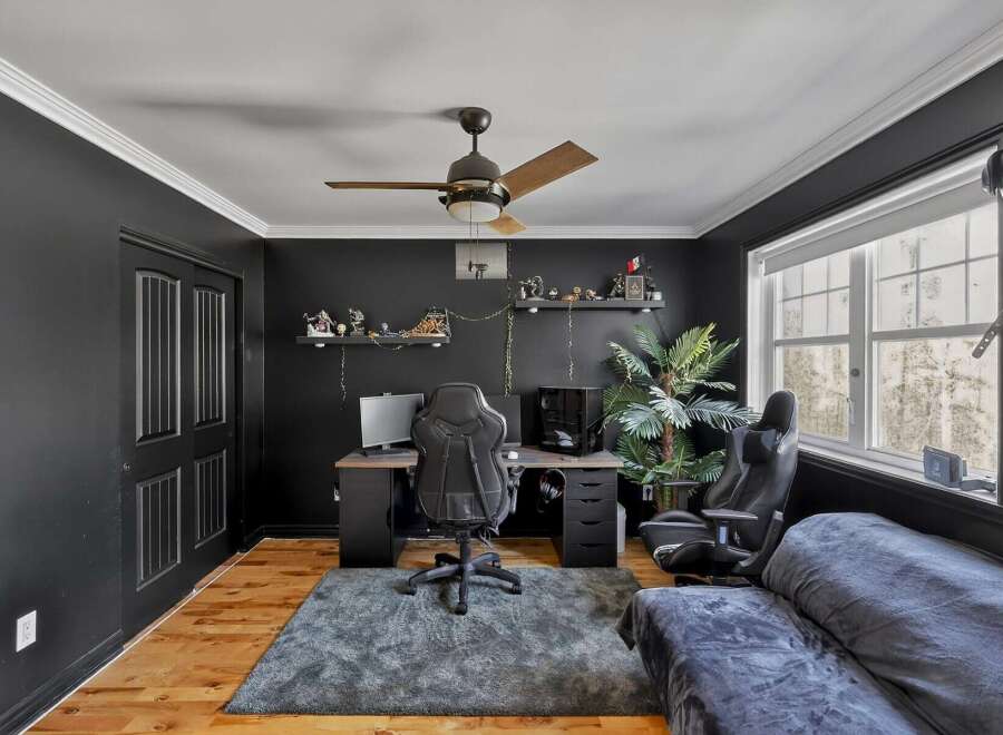 Step into this stylish home office, featuring a sleek black aesthetic and modern design.