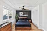 This stunning bedroom boasts a modern design with a dark accent wall, creating a sophisticated ambiance.
