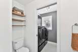 Step into this beautifully designed laundry room, featuring modern appliances and ample storage.
