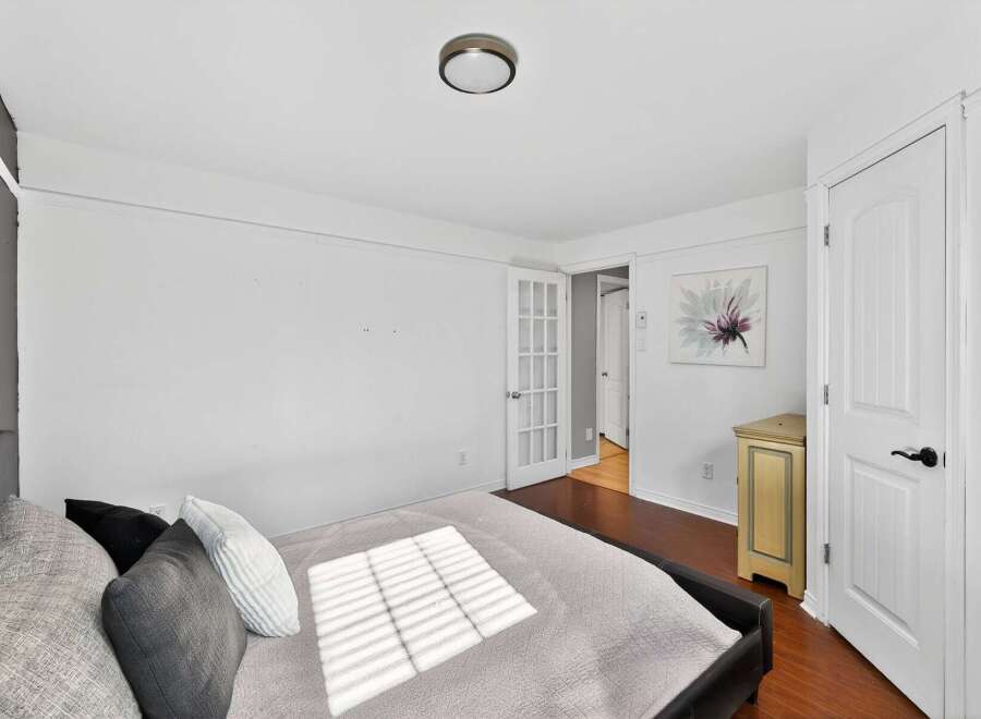 Discover the charm of this inviting bedroom, featuring a comfortable bed and ample natural light.