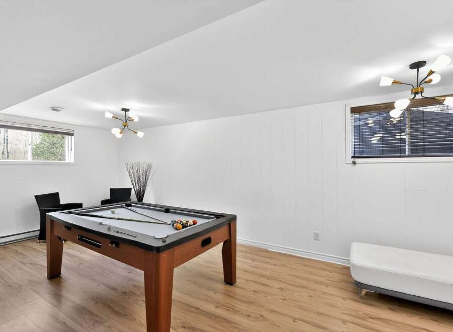 This stunning property boasts a spacious game room, perfect for entertaining guests or enjoying a relaxing evening.