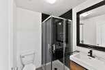 Step into this modern bathroom featuring a sleek glass shower enclosure and contemporary fixtures.