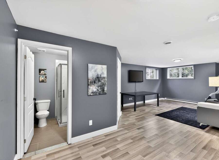 This stunning property boasts a modern interior with a spacious living area and a well-appointed bathroom.