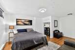 Discover the charm of this inviting bedroom, featuring a cozy bed and a stylish lamp.