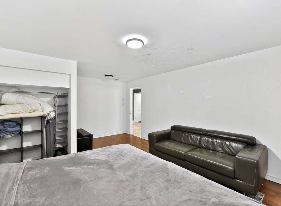 This spacious bedroom offers a comfortable retreat with ample natural light and modern design.