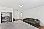 This spacious bedroom offers a comfortable retreat with ample natural light and modern design.