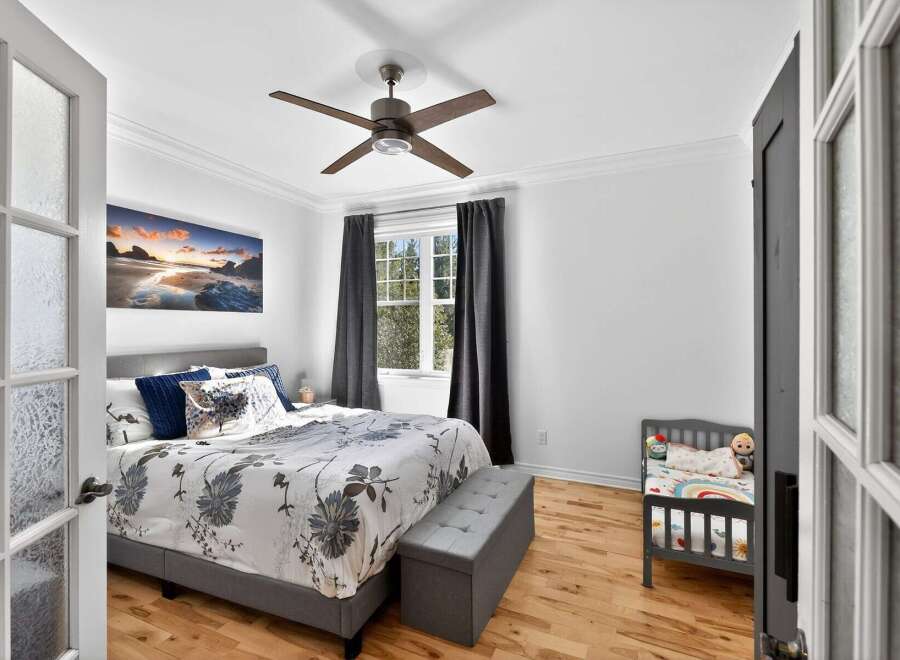 Step into this inviting bedroom, featuring a comfortable bed with stylish bedding and a cozy seating area.