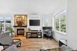 This stunning living room boasts a cozy fireplace adorned with a captivating lion artwork, creating a focal point that exudes warmth and character.