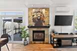 This stunning property boasts a cozy fireplace adorned with a captivating lion artwork, creating a focal point for the living space.