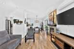 Step into luxury with this stunning property! Featuring a modern living space with hardwood floors, a cozy fireplace, and a sleek entertainment center.