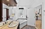Step into luxury with this stunning bathroom featuring a unique, heart-shaped tub and a stylish vanity.