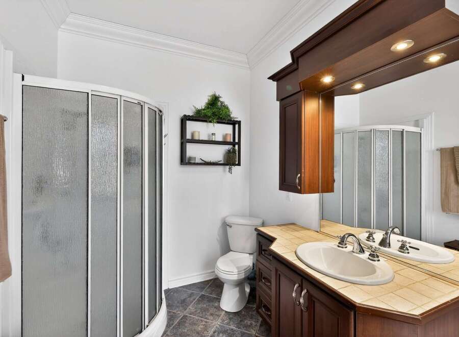 Step into this beautifully designed bathroom featuring a modern shower and a stylish vanity.