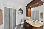 Step into this beautifully designed bathroom featuring a modern shower and a stylish vanity.