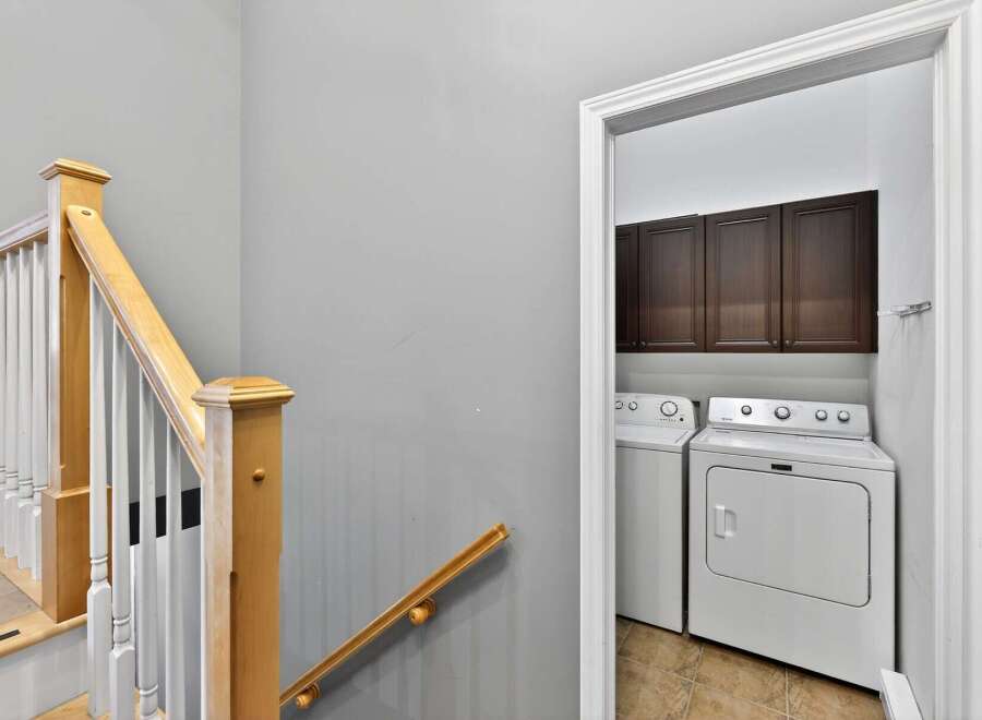 This property features a well-lit laundry room with modern appliances and ample storage.