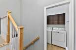 This property features a well-lit laundry room with modern appliances and ample storage.