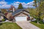 This charming home boasts a beautiful exterior with a well-maintained lawn and a spacious driveway.