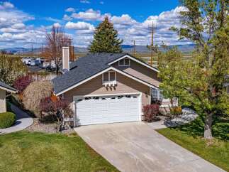 This charming home boasts a beautiful exterior with a well-maintained lawn and a spacious driveway.