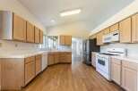 Step into this inviting kitchen, featuring ample cabinet space and modern appliances.