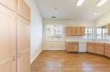 Step into this inviting kitchen, featuring ample cabinet space and a bright, airy atmosphere.