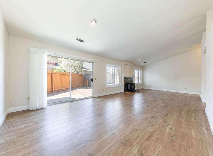 Step into this inviting living space, featuring a seamless blend of natural light and modern design.