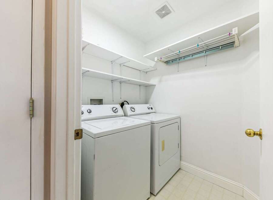 This laundry room offers a bright and functional space for your laundry needs.