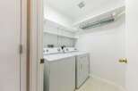 This laundry room offers a bright and functional space for your laundry needs.