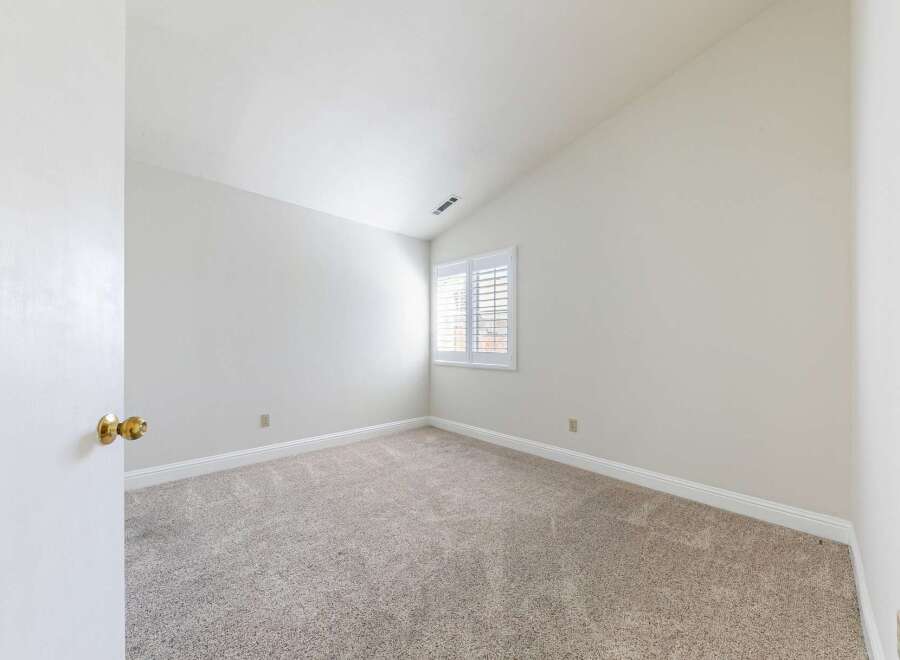 Discover the charm of this inviting room, featuring a neutral color palette and plush carpeting.