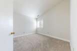 Discover the charm of this inviting room, featuring a neutral color palette and plush carpeting.