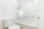 Step into this bright and clean bathroom, featuring a pristine white bathtub and shower combo.