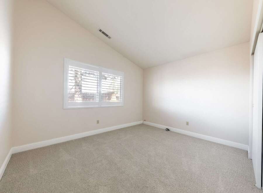 This inviting room features a neutral color palette, creating a versatile space ready for personalization.