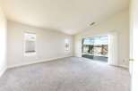 Step into this bright and airy living space, featuring a vaulted ceiling and ample natural light.