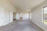 Step into this spacious bedroom, featuring a vaulted ceiling that amplifies the sense of openness.
