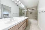 Step into this beautifully designed bathroom featuring a double vanity with ample counter space and storage.