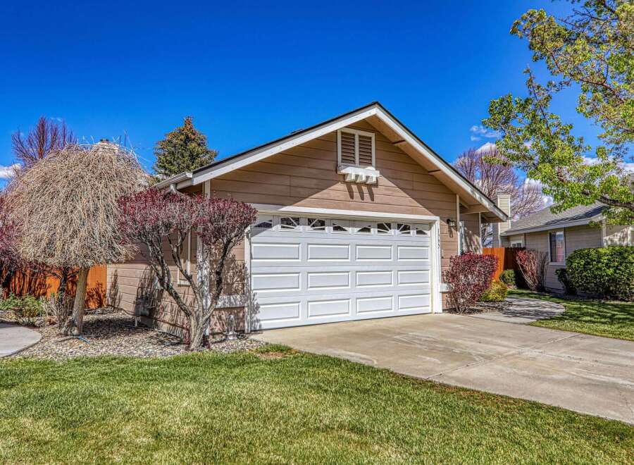 This charming home boasts a beautiful exterior with a well-maintained lawn and lush landscaping.