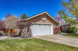 This charming home boasts a beautiful exterior with a well-maintained lawn and lush landscaping.