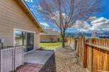 Enjoy the beauty of this property's outdoor space, featuring a charming patio and a well-maintained wooden fence.