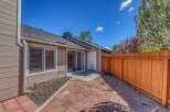 Enjoy outdoor living in this charming patio space! Featuring a brick patio, a wooden fence, and a sliding glass door, this area is perfect for relaxation and entertaining.