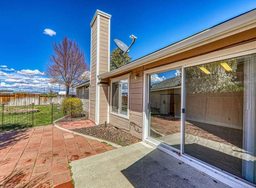 Enjoy outdoor living in this beautiful home with a spacious patio and a well-maintained yard.