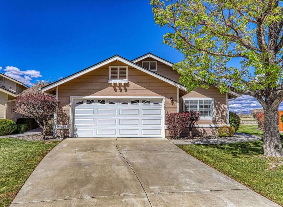 Discover this charming property featuring a spacious driveway and a well-maintained lawn.