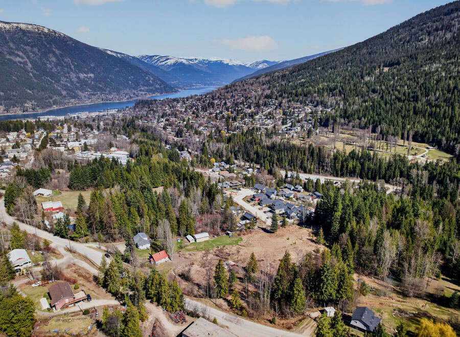 Nestled in a picturesque valley, this property offers stunning views of the surrounding mountains and a serene lake.