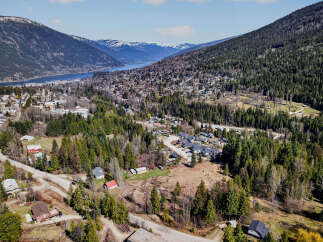 Nestled in a picturesque valley, this property offers stunning views of the surrounding mountains and a serene lake.