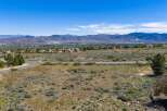 Discover the breathtaking beauty of this expansive property, offering stunning panoramic views of the surrounding mountains and valley.