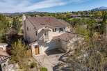 This stunning property boasts a beautiful tile roof and a charming balcony, perfect for enjoying the scenic views.