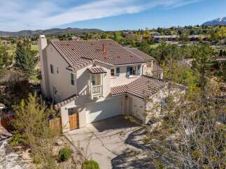 This stunning property boasts a beautiful tile roof and a charming balcony, perfect for enjoying the scenic views.