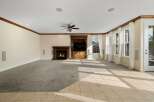 Step into luxury with this stunning living room, featuring a cozy fireplace and a built-in entertainment center.